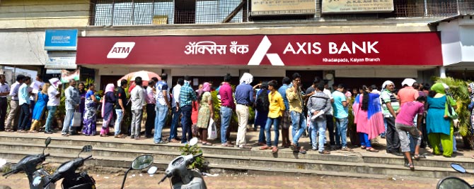 people lining up in front of bank in india