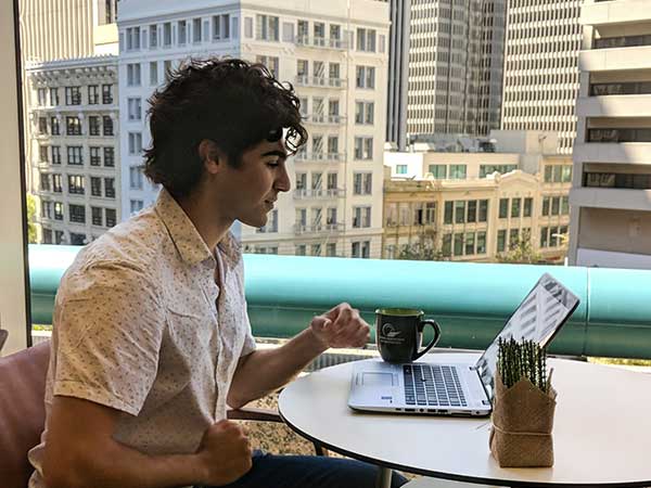 SF Fed Intern Sevan Garibian works from the SF Fed cafeteria