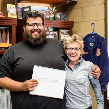 President Mary Daly with a community leader holding a sign reading: amazing