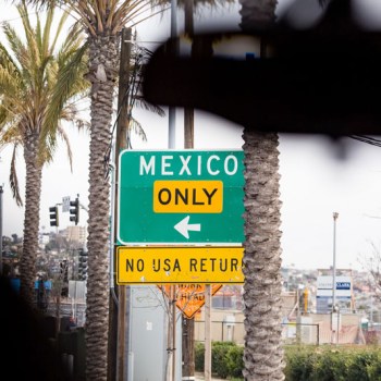 Street sign reads: Mexico only, no USA return