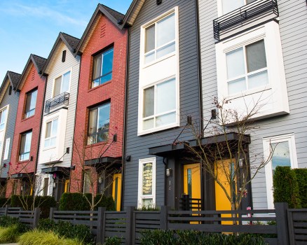 A row of new real estate townhouses or condominiums.
