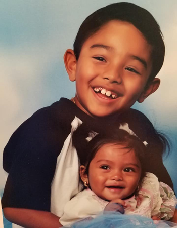 Angel as a child with his baby sister.