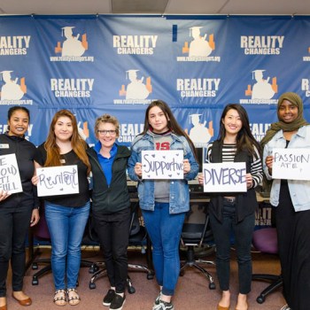 President Mary Daly with 5 community leaders holding oversized cards reading: be (you) tiful, resilient, supportive, diverse, passionate