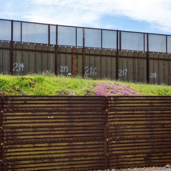 Rusted metal fence at U.S.-Mexico border