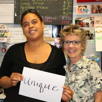 President Mary Daly with a community leader holding a sign reading: unique