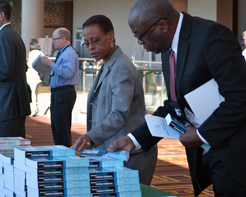 Photo of man and woman looking at Community Development books