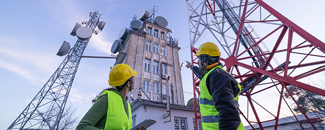 Engineers inspecting communications tower.