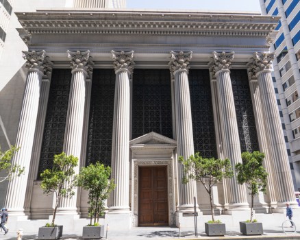 Front of a bank with columns.