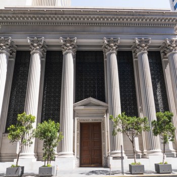 Front of a bank with columns.