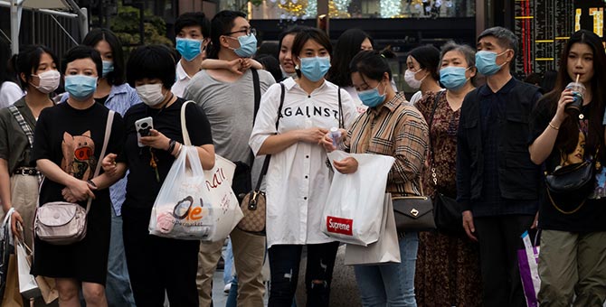 People wearing face masks while shopping in downtown Chengdu, China