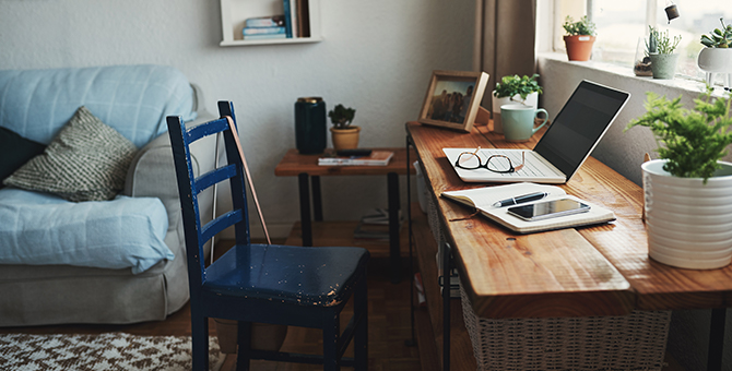 Laptop setup on table in living room for remote work