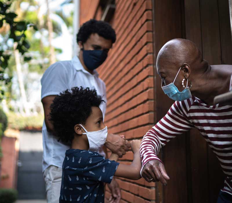 Child, parent, and grandparent wearing masks