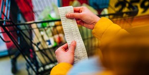 Person checking the bill when paying at a supermarket