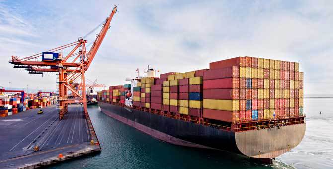 Cargo ship near a dock with shipping containers