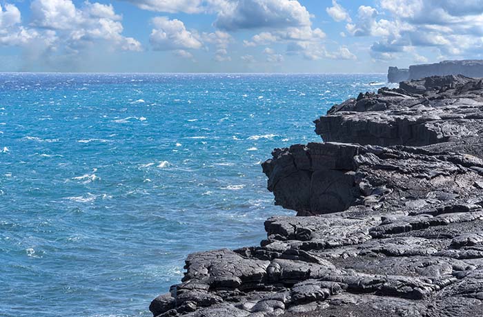 Edge of a cooled lava flow into the Pacific Ocean. Hawaii Volcanoes National Park. Big Island, Hawaii.