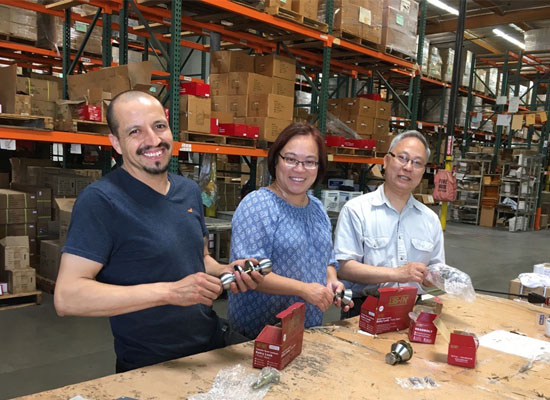 Caron Ng and her team assemble locks in a warehouse.