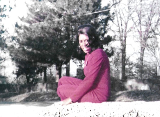 Leola Jackson sitting in front of trees