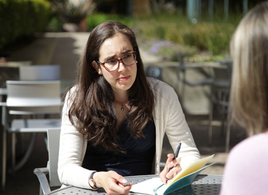 Rocio takes notes during an interview.