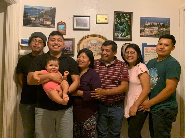 Richard, second from the left and holding his baby niece, poses with his younger brother, mother, stepfather, sister, and brother-in-law.