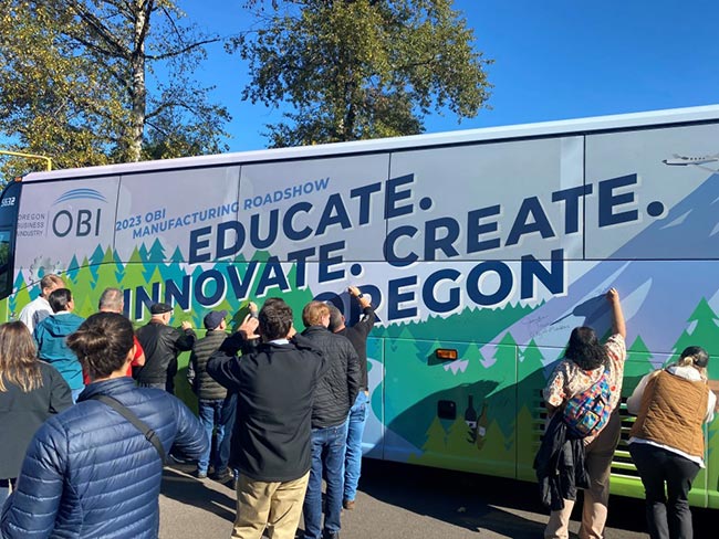 Signing the Roadshow Bus.