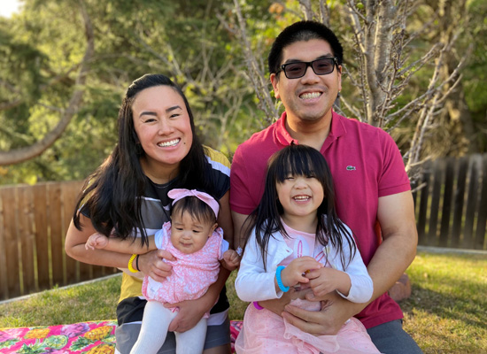 Jordan with his wife and two children in their backyard