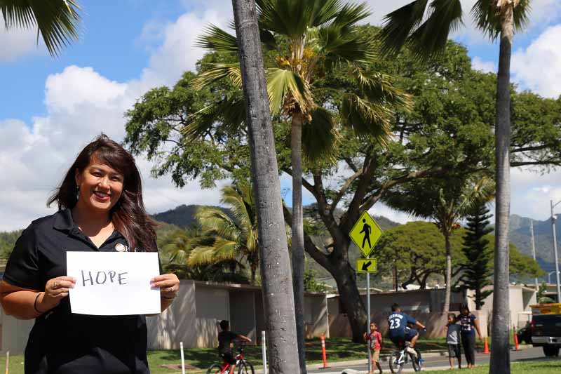 Kim Gillis-Robello holds sign reading Hope