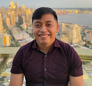 Richard Argueta-Xiloj smiling with view of skyline behind