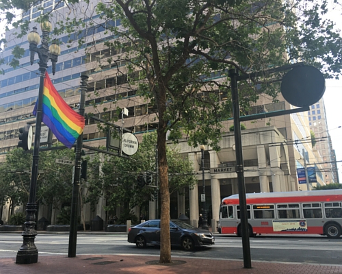 Photo of LGBT Pride flag on Market Street San Francisco towards SF Fed headquarters