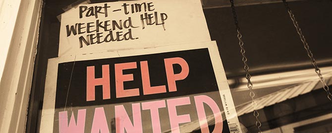 a help wanted storefront sign that reads: part-time weekend help needed.