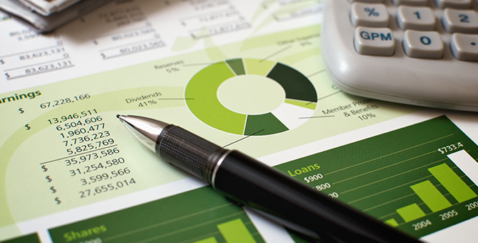 balance sheet, pen, and calculator