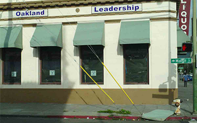 Charter school with mattress in front on sidewalk