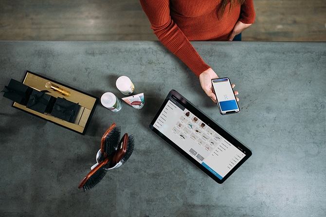 Person using smartphone payment app for in-store purchase 