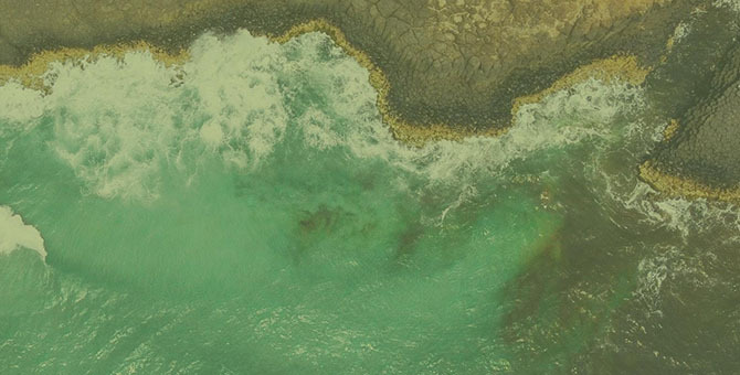 Ocean waves hitting a shoreline
