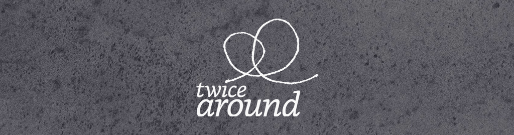 Twice Around logo on top of a gray texture background