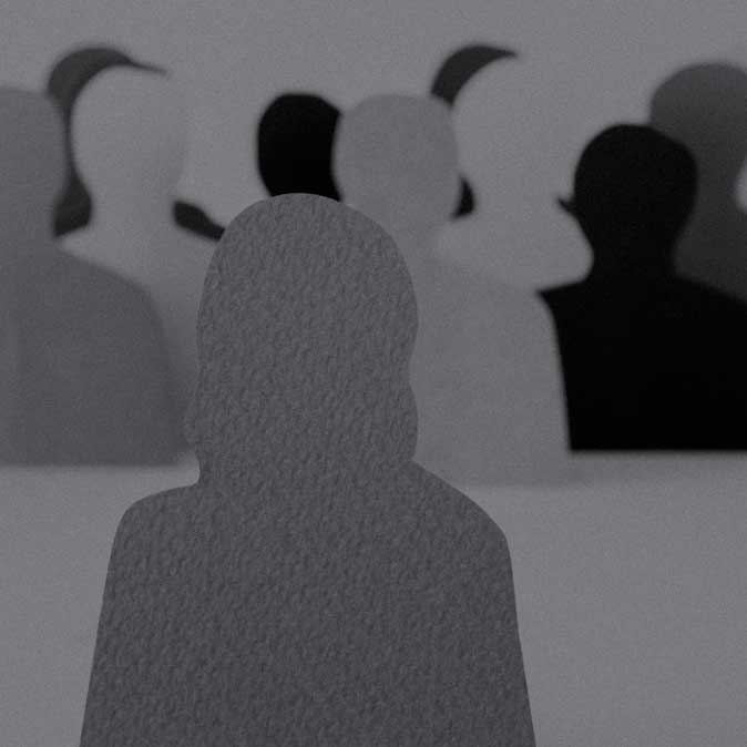 Diverse group of people looking paper cut-outs