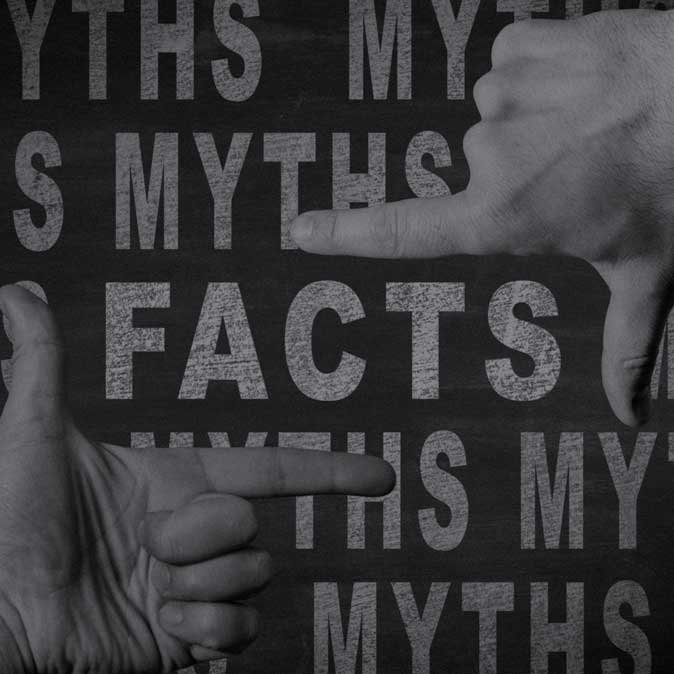 Two hands with their index finger and thumbs framing the words 'Facts' and 'Myths' in the background.